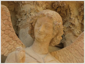 West front north portal, left side, 'Smiling Angel' (after 1252) (detail), Reims Cathedral click for full-size image