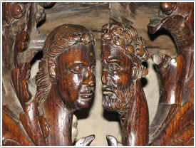 Choir stalls, southwest junction, 2 heads (1535), St-Bertrand-de-Comminges Cathedral
