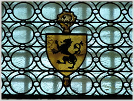 Window with lion ensign in nave, St-Pons-de-Thomières Cathedral click for full-size image