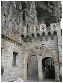 Arch with trefoil in rampart wall leading into parvis, Rocamadour click for full-size image