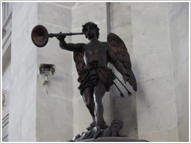 'Angel blowing trumpet,' top of pulpit (18th c.), south nave aisle, La Rochelle Cathedral click for full-size image