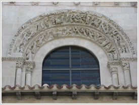 Tympanum (12th c.) above west front portal, Église Ste-Eulalie, Benet click for full-size image